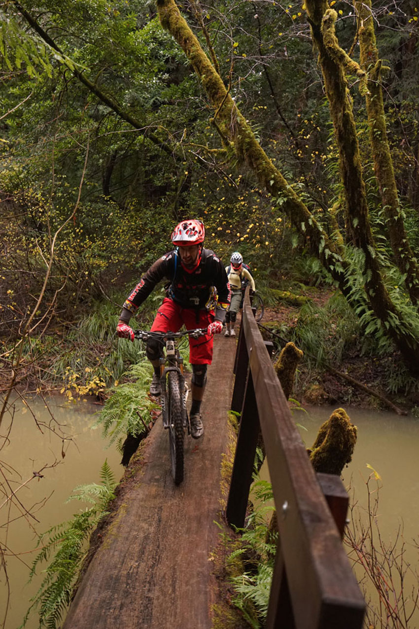 Log bridge over flood stage waters of the Little North Fork of Big River (say that ten times fast)… looks wider than it is. Photo: Mendocino Bike Sprite
